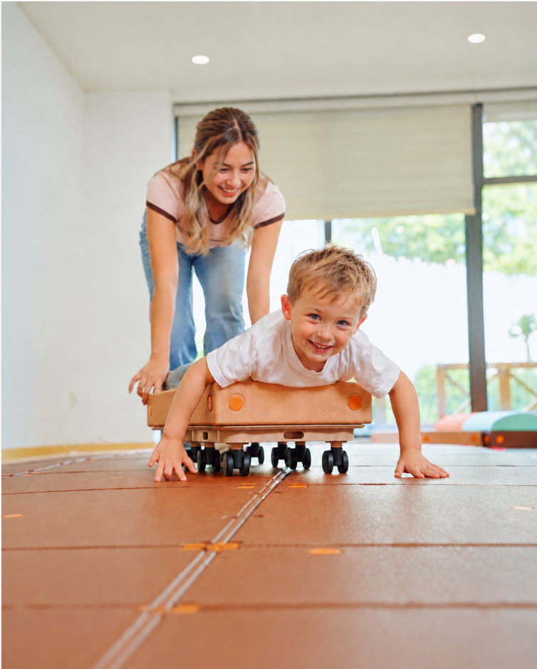 Young child exploring self-awareness and spatial symmetry with Egoo folding multi-angle sensory floor mirror